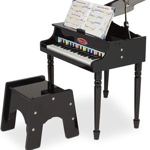 New in box. Melissa and Doug baby grand piano.
